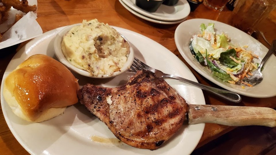 Printed menu with comfort food and drinks.